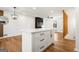 White kitchen island with quartz countertop and gold hardware at 130 Belmont Farms Dr, Ellenwood, GA 30294