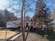 House exterior showcasing wrap-around porch and mature trees at 353 Gum Creek Rd, Oxford, GA 30054