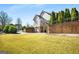 Home's exterior showcasing side view, driveway and landscaping at 415 Burbury Close, Fayetteville, GA 30215