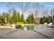 Inviting swimming pool with spacious patio and lush landscaping at 415 Burbury Close, Fayetteville, GA 30215