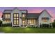 Stunning two-story farmhouse with white exterior, metal roof, and stone accents at 0 Matteo Way # 34, Fayetteville, GA 30215