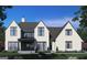 Rear view of a two-story home with brick exterior, metal roof, and landscaping at 0 Matteo Way # 20, Fayetteville, GA 30215