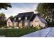 Modern farmhouse style home with brick and dark siding, landscaping, and a paved driveway at 0 Matteo Way # 7, Fayetteville, GA 30215