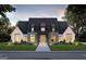 Stunning two-story home with brick and shingle exterior, landscaping, and a large driveway at 0 Matteo Way # 9, Fayetteville, GA 30215