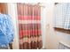 Bathroom with shower, striped curtain, and towels at 215 Creekside Trl, Fayetteville, GA 30214