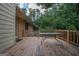 Wooden deck with table, offering a relaxing outdoor space at 215 Creekside Trl, Fayetteville, GA 30214