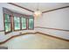 Bright dining room featuring a bay window and elegant light fixture at 215 Creekside Trl, Fayetteville, GA 30214