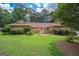 Brick ranch house with a spacious lawn and mature trees at 215 Creekside Trl, Fayetteville, GA 30214
