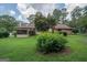 Brick house with screened porch and green lawn at 215 Creekside Trl, Fayetteville, GA 30214