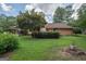 Brick house with green lawn and mature landscaping at 215 Creekside Trl, Fayetteville, GA 30214