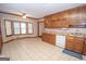 Kitchen with wood cabinets and granite countertops at 215 Creekside Trl, Fayetteville, GA 30214