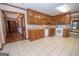 Kitchen with wood cabinets, granite counters, and tile floor at 215 Creekside Trl, Fayetteville, GA 30214