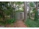 Gray storage shed nestled in a wooded area at 215 Creekside Trl, Fayetteville, GA 30214