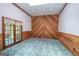 Sunroom with wood walls, carpet, and French doors at 215 Creekside Trl, Fayetteville, GA 30214