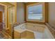 Relax in this bathroom's luxurious corner jetted tub at 12178 Brown Bridge Rd, Covington, GA 30016