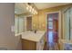 Modern bathroom vanity with a large mirror and updated light fixtures at 12178 Brown Bridge Rd, Covington, GA 30016