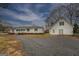 A single story home with large yard and a detached garage on a stone driveway at 12178 Brown Bridge Rd, Covington, GA 30016