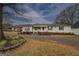 Well-maintained single story home with a covered carport and mature trees at 12178 Brown Bridge Rd, Covington, GA 30016