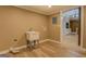 Laundry room with utility sink and view into kitchen area at 12178 Brown Bridge Rd, Covington, GA 30016