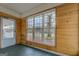 Bright sunroom with wood paneling and large windows offering a view of the backyard at 12178 Brown Bridge Rd, Covington, GA 30016