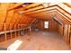 Large unfinished attic space with exposed beams at 12178 Brown Bridge Rd, Covington, GA 30016