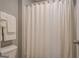Bright bathroom featuring a white shower curtain, toilet, and towel racks with white towels at 4128 Pemberton Dr, Covington, GA 30014