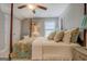 Cozy bedroom with a four poster bed with floral bedding, window with blinds, and stylish decor at 4128 Pemberton Dr, Covington, GA 30014