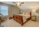 Comfortable bedroom featuring a ceiling fan, natural light from the window, and a sleigh bed at 4128 Pemberton Dr, Covington, GA 30014