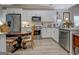 Well-lit kitchen featuring white cabinets, granite countertops, and stainless steel appliances at 4128 Pemberton Dr, Covington, GA 30014