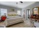 This main bedroom offers a calm space, with wood floors, neutral walls, and a cream-colored bed at 4128 Pemberton Dr, Covington, GA 30014