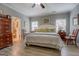 A cozy main bedroom features wood floors, neutral paint, a ceiling fan, and bright natural light at 4128 Pemberton Dr, Covington, GA 30014