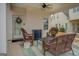 Inviting covered patio featuring wicker furniture, ceiling fan, and a peaceful outdoor setting at 4128 Pemberton Dr, Covington, GA 30014