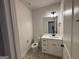 Modern bathroom with white vanity and patterned tile floor at 8795 St Patrick'S Way # 2, Winston, GA 30187