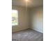 Bright bedroom with carpeted floors and a large window at 9168 Carr Cir, Covington, GA 30014