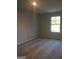 Simple bedroom with grey carpet and a window at 9168 Carr Cir, Covington, GA 30014