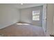 Bright bedroom with carpeted floor and large window at 100 Heyman Dr, Covington, GA 30016