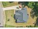 A bird's eye view reveals the home's roof structure, driveway, and landscaping details at 4051 Rotterdam Pass, Hampton, GA 30228