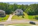 An elevated view showcases this two-story home, its lush lawn, and convenient street access at 4051 Rotterdam Pass, Hampton, GA 30228