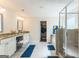 Bright bathroom with double vanity, walk-in closet, and glass shower at 4051 Rotterdam Pass, Hampton, GA 30228