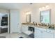 Double vanity in well-lit bathroom with granite countertop at 4051 Rotterdam Pass, Hampton, GA 30228