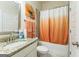 Well-lit bathroom featuring a tub and shower combo with stylish orange accents at 4051 Rotterdam Pass, Hampton, GA 30228