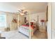Traditional bedroom with a four-poster bed, ceiling fan, and coordinated furniture at 4051 Rotterdam Pass, Hampton, GA 30228