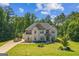 Beautiful two-story brick home featuring an attached three-car garage and professionally landscaped front yard at 4051 Rotterdam Pass, Hampton, GA 30228