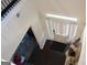 View from the upper level of the foyer with hardwood floors, white walls, front door and area rug at 4051 Rotterdam Pass, Hampton, GA 30228