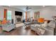 Comfortable living room with stone fireplace, leather seating, and a large television at 4051 Rotterdam Pass, Hampton, GA 30228