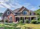 Two-story brick house with stone accents and a large porch at 10 Toscanno Dr, Covington, GA 30014