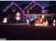 Festive two-story home decorated with colorful Christmas lights and inflatable holiday characters in the front yard at 10 Toscanno Dr, Covington, GA 30014