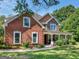Two story brick home with stone accents and a large front porch at 10 Toscanno Dr, Covington, GA 30014