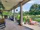 Spacious front porch with seating and landscaping at 10 Toscanno Dr, Covington, GA 30014