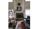 Living room with a stone fireplace, mantle decorated for the holidays and festive decor throughout at 10 Toscanno Dr, Covington, GA 30014